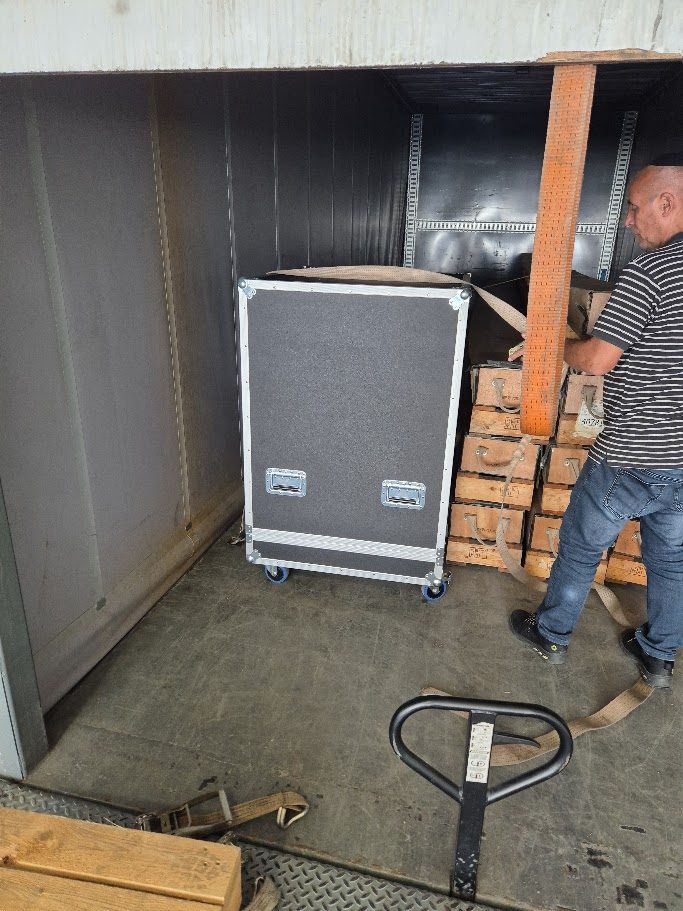 Loading a flight case into a truck for transport