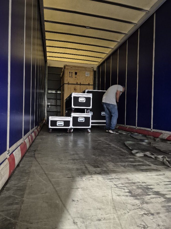 Flight cases being loaded into a truck for an international exhibition